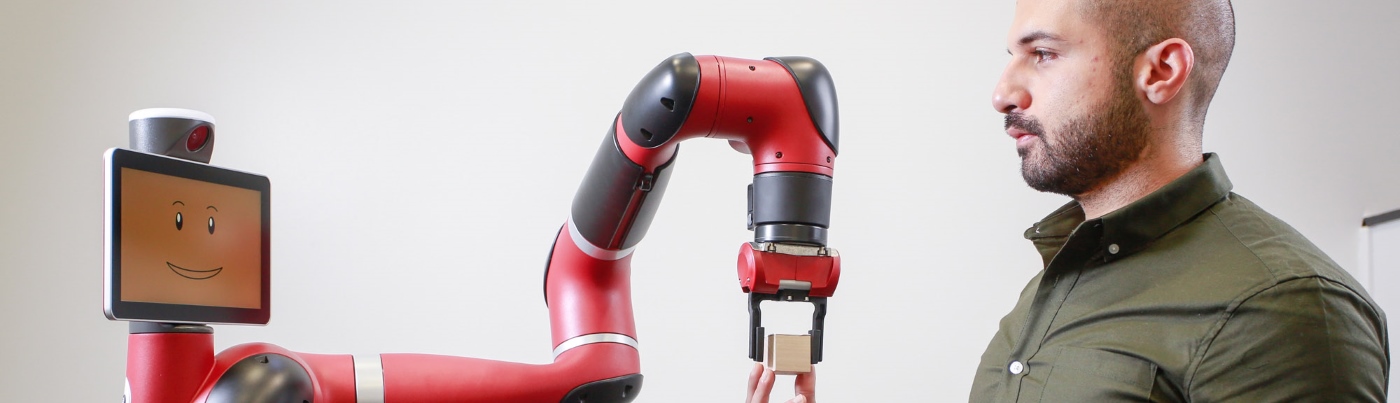 Scientist programming a robot arm 